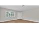 A light and airy bedroom with hardwood floors, a window, and a closet at 208 Ne Lincoln N Cir, St Petersburg, FL 33702