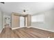Spacious bedroom featuring wood floors, a ceiling fan, and a barn door for a closet at 208 Ne Lincoln N Cir, St Petersburg, FL 33702
