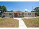 Charming single-story home with stone accents, and a welcoming walkway leading to the front door at 208 Ne Lincoln N Cir, St Petersburg, FL 33702