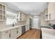 Bright kitchen features updated cabinets, countertops, modern appliances, and stylish hardwood floors at 208 Ne Lincoln N Cir, St Petersburg, FL 33702