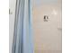 Bathroom tiled shower features shower curtain, tiled walls, and a mounted soap dispenser at 2215 Thrace St, Tampa, FL 33605