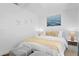Comfortable bedroom featuring shiplap walls, soft lighting, and stylish striped ottomans at 2215 Thrace St, Tampa, FL 33605