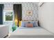 Charming bedroom featuring light blue accents, green drapes, and stylish coastal touches at 2215 Thrace St, Tampa, FL 33605