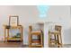 Coastal-style dining area featuring rattan chairs, bar cart, and a neon 