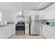 Bright kitchen with stainless steel appliances, white cabinetry, and sleek countertops at 2215 Thrace St, Tampa, FL 33605