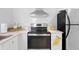 Bright kitchen with white subway tile, stainless steel appliances and white countertops at 2215 Thrace St, Tampa, FL 33605