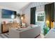 Comfortable living room featuring stylish grey sofa, and modern beach-themed decor at 2215 Thrace St, Tampa, FL 33605