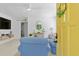 Bright living room with a yellow door, comfortable seating, and charming nautical decor at 2215 Thrace St, Tampa, FL 33605
