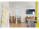 Living room with bar stools, a flat screen television, and a neon sign, accessed through a yellow door at 2215 Thrace St, Tampa, FL 33605