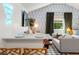 Open-concept living space featuring inviting sofa, functional bar, and stylish decor at 2215 Thrace St, Tampa, FL 33605