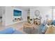 Open living room with a large TV, nautical decor, and comfortable blue seating at 2215 Thrace St, Tampa, FL 33605