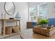 Bright living room featuring nautical decorations, a round mirror, and comfortable seating at 2215 Thrace St, Tampa, FL 33605