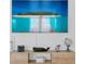 Close up of a TV on a wall showing a topical image of a pier over clear water at 2215 Thrace St, Tampa, FL 33605