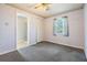 Bedroom with neutral carpet, white closet, and window, offering a bright and airy space at 23701 Harmony Ln, Land O Lakes, FL 34639
