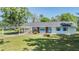 Charming single-story home features a brick facade and lovely blue shutters and door at 23701 Harmony Ln, Land O Lakes, FL 34639