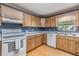 Classic kitchen with wood cabinets, white marble countertops, and modern appliances at 23701 Harmony Ln, Land O Lakes, FL 34639