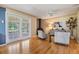 Bright room featuring hardwood floors, stylish seating, and sliding glass doors at 23701 Harmony Ln, Land O Lakes, FL 34639