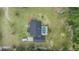 Aerial view of a home with a backyard pool surrounded by lush greenery and palm trees at 23717 Harmony Ln, Land O Lakes, FL 34639
