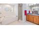 Bathroom featuring a tub, walk-in shower, sink, and vanity at 23717 Harmony Ln, Land O Lakes, FL 34639