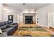 Living room featuring a large TV, hardwood floors, and plenty of seating at 23717 Harmony Ln, Land O Lakes, FL 34639