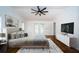 Bright bedroom with a ceiling fan and french doors that lead to the outside at 2392 Hillcreek E Cir, Clearwater, FL 33759