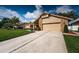 Inviting single-Gathering home with brick facade, manicured lawn, and a spacious two-car garage at 2392 Hillcreek E Cir, Clearwater, FL 33759