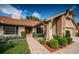Beautiful one-story home featuring a brick pathway, lush landscaping, and a well-maintained facade at 2392 Hillcreek E Cir, Clearwater, FL 33759