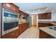 Modern kitchen with stainless steel appliances, granite countertops, tile backsplash, and wooden cabinetry at 2392 Hillcreek E Cir, Clearwater, FL 33759