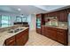 Spacious kitchen features stainless appliances, wood cabinets, granite counters and tile floors at 2392 Hillcreek E Cir, Clearwater, FL 33759