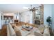 Bright living room featuring a brick fireplace, hardwood floors, and a view of the kitchen at 2392 Hillcreek E Cir, Clearwater, FL 33759