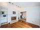 Bright living room featuring hardwood floors, fireplace with mantle and tile surround, and built-in shelving at 2392 Hillcreek E Cir, Clearwater, FL 33759