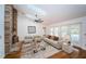 Bright living room with high ceilings, brick fireplace, skylights, and view to pool at 2392 Hillcreek E Cir, Clearwater, FL 33759