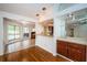 Open living space with bar area, tile flooring, and sliding glass doors to pool area at 2392 Hillcreek E Cir, Clearwater, FL 33759