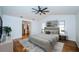 Bright and airy main bedroom with a king bed and a view into the bathroom at 2392 Hillcreek E Cir, Clearwater, FL 33759