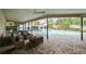 The screened lanai offers both covered seating and a view of the pool and yard at 2392 Hillcreek E Cir, Clearwater, FL 33759