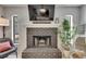Close-up of the brick fireplace with a decorative mantle and view to the outdoor area at 2420 Forrest Crest Cir, Lutz, FL 33549