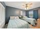 Bedroom with two twin beds, overhead ceiling fan, gray walls and a large closet behind louvered doors at 2427 Twin Dr # 2, Sarasota, FL 34234