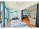 Sunroom with views, twin bed, surfboard decor, that opens to another room with TV and seating at 2427 Twin Dr # 2, Sarasota, FL 34234