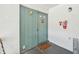 Inviting condo entryway with a charming light-blue door, a welcome mat, and wood plank accent wall at 2427 Twin Dr # 2, Sarasota, FL 34234