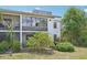 Exterior view of a two-story home with large windows and a garden at 2427 Twin Dr # 2, Sarasota, FL 34234