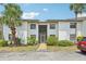Well-maintained two-story condo with stucco exterior and landscaped grounds with mature palms at 2427 Twin Dr # 2, Sarasota, FL 34234