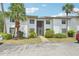 Well-maintained two-story condo with stucco exterior and landscaped grounds with mature palms at 2427 Twin Dr # 2, Sarasota, FL 34234
