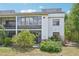 Exterior view of a two-story home with large windows and a garden at 2427 Twin Dr # 2, Sarasota, FL 34234