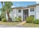 Well-maintained two-story condo with stucco exterior and landscaped grounds with mature palms at 2427 Twin Dr # 2, Sarasota, FL 34234