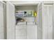 Laundry room features washer, dryer and shelving for ample storage, all behind white louvered doors at 2427 Twin Dr # 2, Sarasota, FL 34234