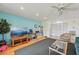 Bright living room featuring hardwood floors, a ceiling fan, and blue accent wall with a view at 2427 Twin Dr # 2, Sarasota, FL 34234