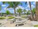 Seating area near pool and palm trees under sunny sky at 2427 Twin Dr # 2, Sarasota, FL 34234