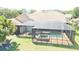 A beautiful home featuring a large screened in pool and overlooking a canal at 2679 Saddlewood Ln, Palm Harbor, FL 34685