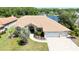 Aerial view of a beautiful home with well-maintained landscaping and a lake view at 2679 Saddlewood Ln, Palm Harbor, FL 34685