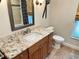 Bathroom vanity with granite counters and decorative mirror at 2679 Saddlewood Ln, Palm Harbor, FL 34685